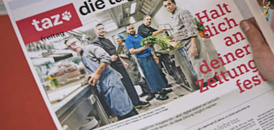 Die „taz“ spart ab heute an Papier, will aber weiter groß tönen